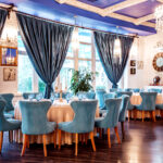 restaurant hall with blue chairs and decors on the wall